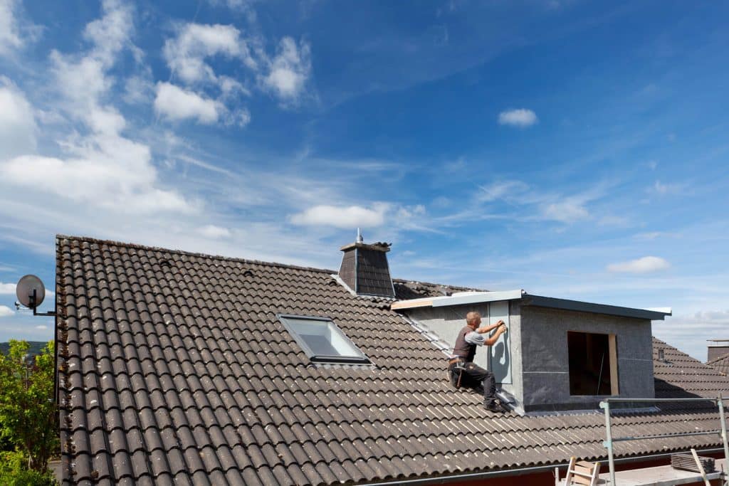 man repairing roof
